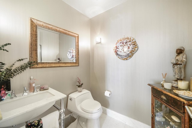 half bathroom featuring a sink and toilet