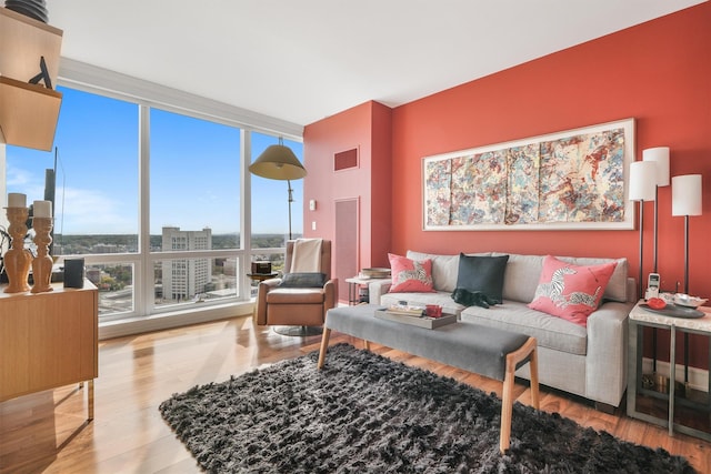 living area with expansive windows and wood finished floors