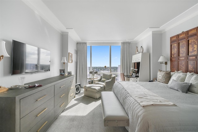 bedroom with floor to ceiling windows, ornamental molding, and carpet