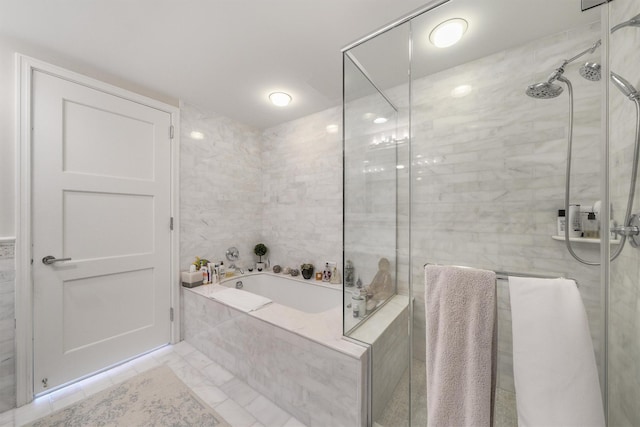 bathroom with a stall shower and a bath