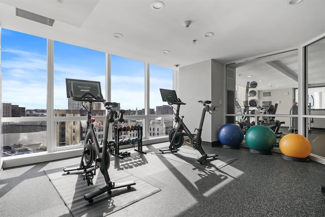 gym with recessed lighting and floor to ceiling windows