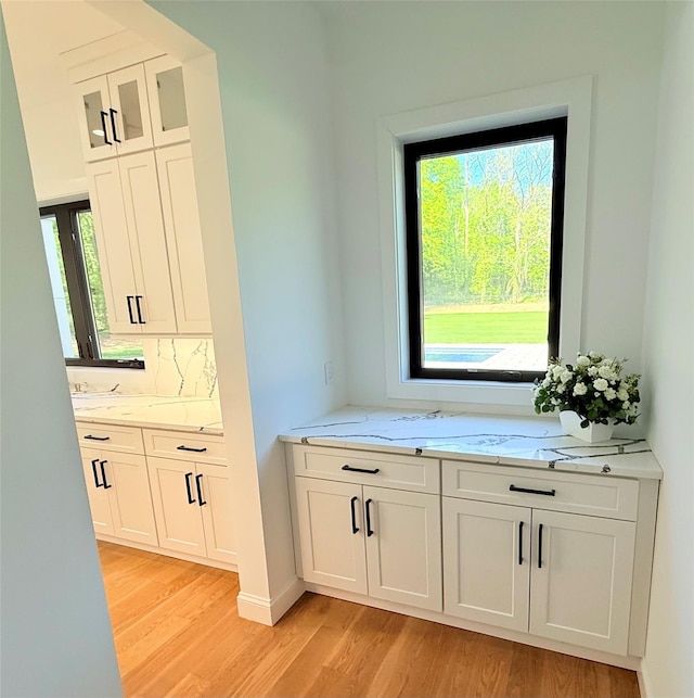 412 Mill River Rd, Oyster Bay, NY 11771 - bar with light wood-type flooring and backsplash