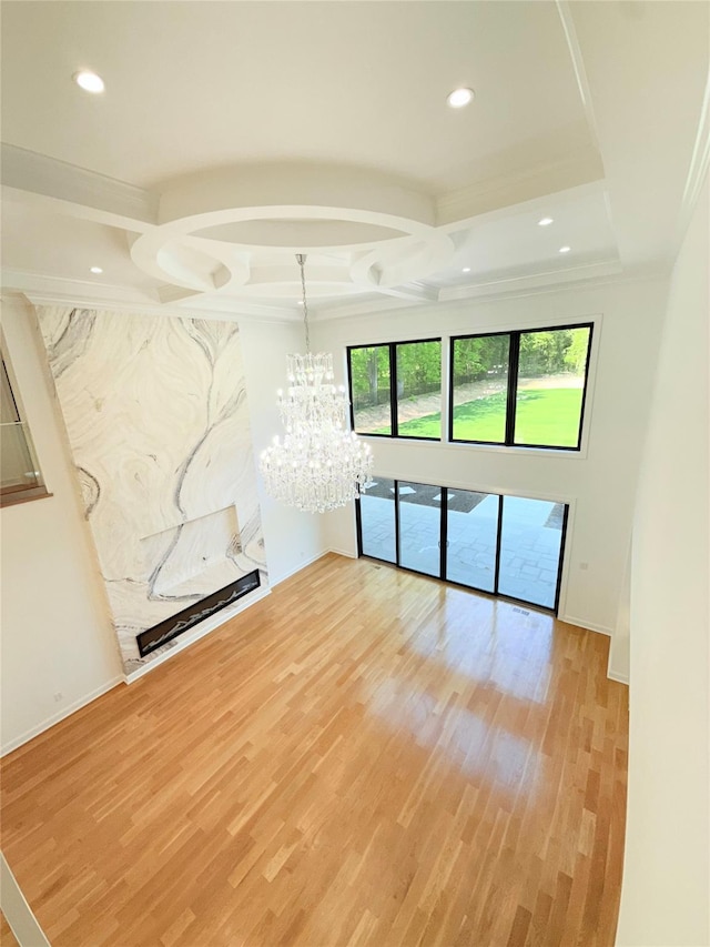 412 Mill River Rd, Oyster Bay, NY 11771 - spare room featuring light wood-style floors, crown molding, recessed lighting, and a notable chandelier
