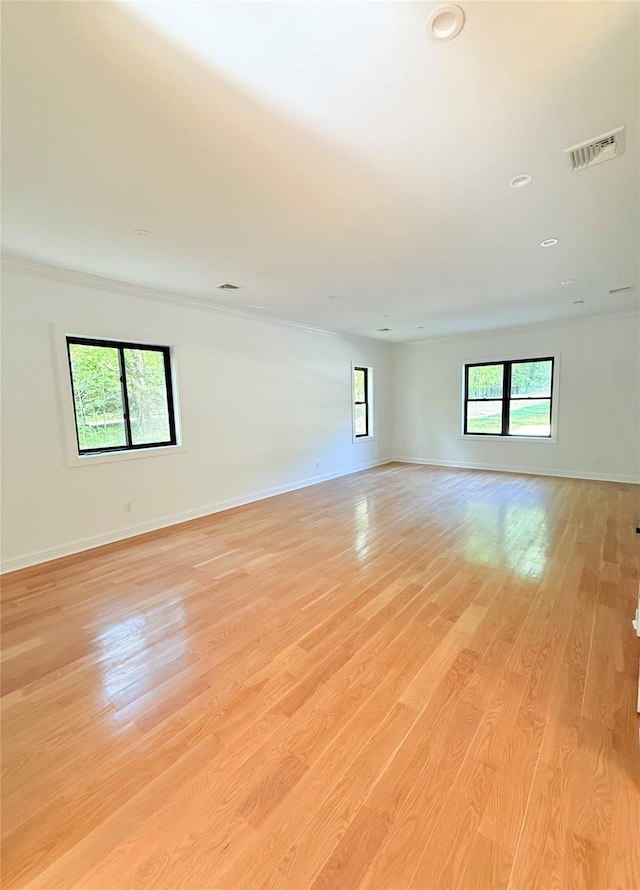 412 Mill River Rd, Oyster Bay, NY 11771 - empty room with visible vents, crown molding, baseboards, recessed lighting, and light wood-style flooring