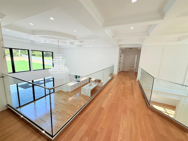 412 Mill River Rd, Oyster Bay, NY 11771 - hall with light wood-style floors, ornamental molding, beamed ceiling, and a notable chandelier