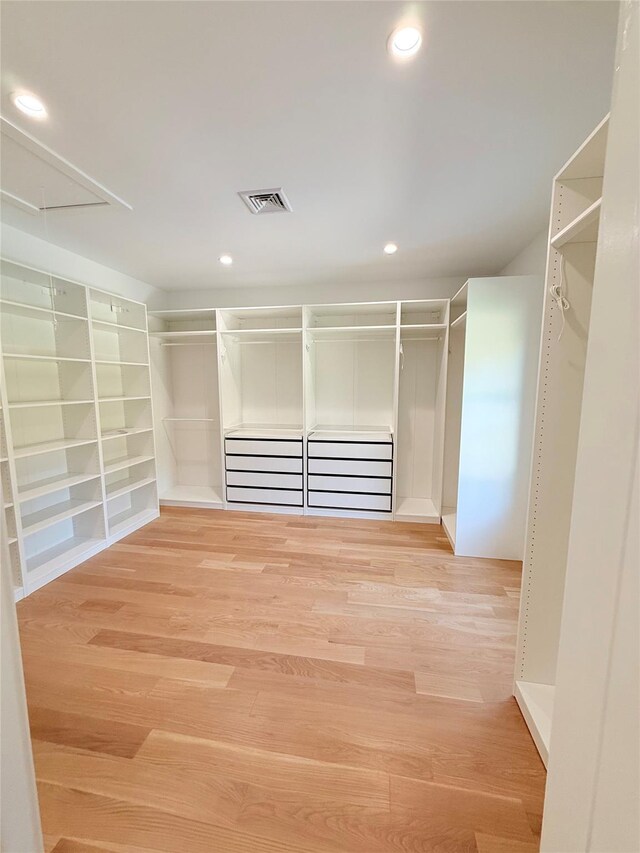 412 Mill River Rd, Oyster Bay, NY 11771 - spacious closet featuring visible vents, light wood-style flooring, and attic access