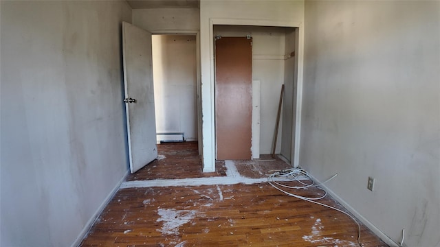 80 Sneden Pl Unit 80, Spring Valley, NY 10977 - unfurnished bedroom with a baseboard heating unit, wood finished floors, and a closet