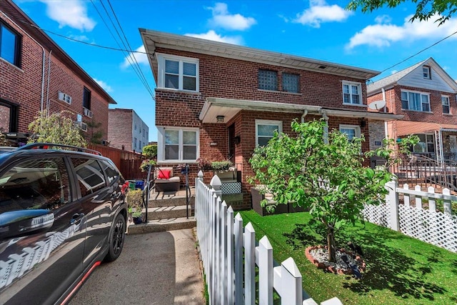 view of front of home with fence private yard and brick siding