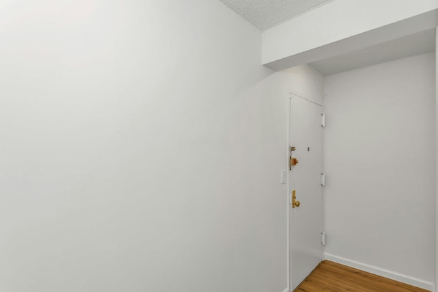57-15 69th Ln # 2, Maspeth, NY 11378 - clothes washing area featuring baseboards, light wood-style flooring, and a textured ceiling