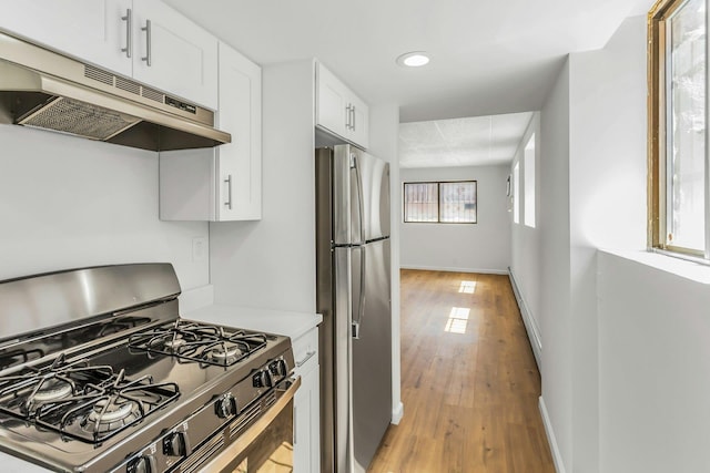 57-15 69th Ln # 2, Maspeth, NY 11378 - kitchen with stainless steel appliances, under cabinet range hood, light wood-style flooring, white cabinets, and light countertops