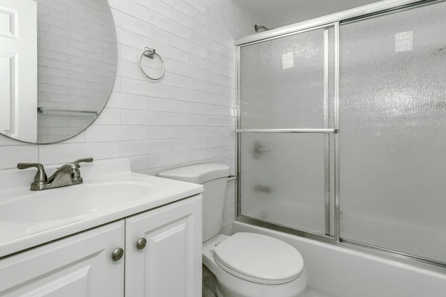57-15 69th Ln # 2, Maspeth, NY 11378 - bathroom with tile walls, shower / bath combination with glass door, toilet, vanity, and backsplash