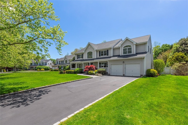 view of front facade featuring asphalt driveway and an attached garage