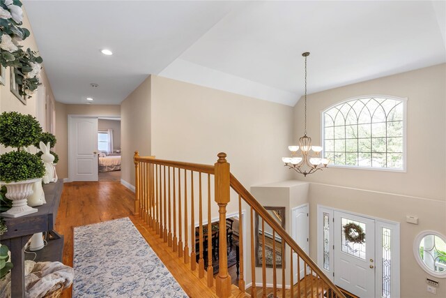 entryway with a chandelier, light wood-style flooring, baseboards, and recessed lighting