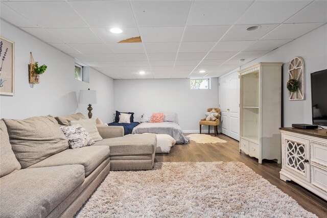 living room with dark wood-style floors, a paneled ceiling, and recessed lighting