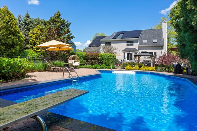 view of swimming pool with a gazebo, a fenced backyard, and a patio