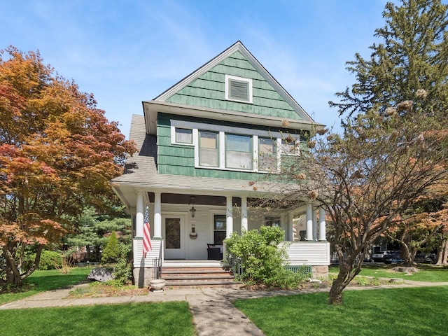 victorian home with a porch and a front lawn