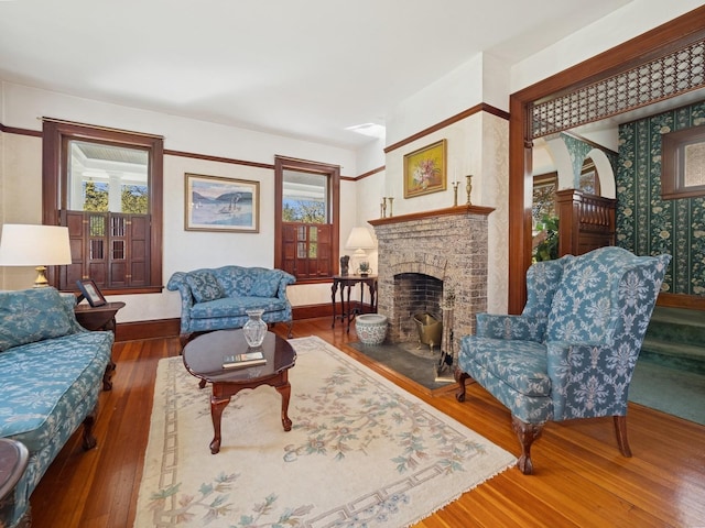 living room with hardwood / wood-style flooring and a fireplace
