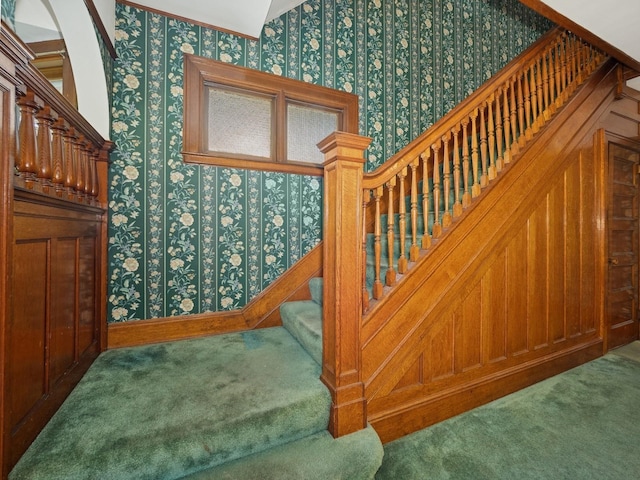 stairway featuring wallpapered walls and carpet