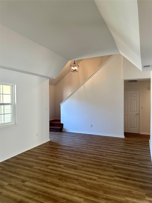 1403 Pebble Beach Path, Riverhead, NY 11901 - unfurnished living room with lofted ceiling, dark wood-style floors, and baseboards