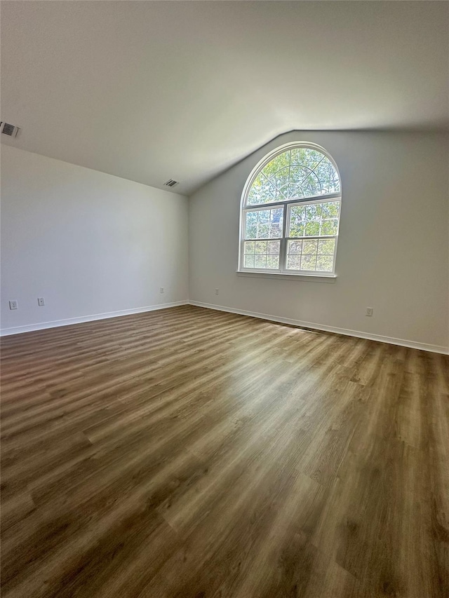 1403 Pebble Beach Path, Riverhead, NY 11901 - unfurnished room featuring lofted ceiling, dark wood-type flooring, and baseboards