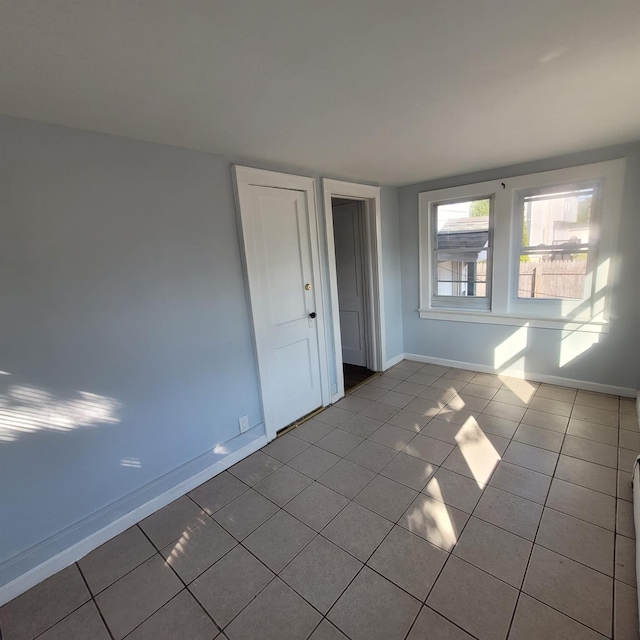 tiled spare room with baseboards
