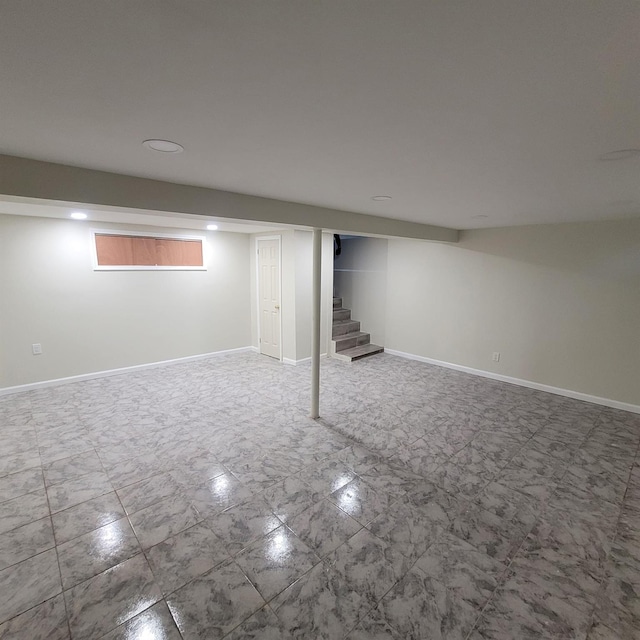 finished basement with baseboards, recessed lighting, and stairway