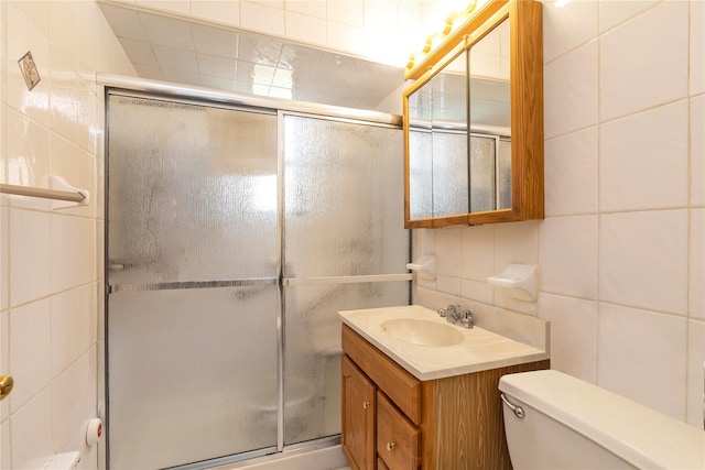 89-12 155th Ave # 1, Howard Beach, NY 11414 - bathroom featuring tile walls, a shower stall, vanity, and toilet