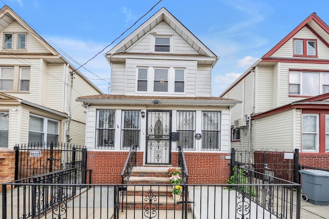 8838 74th Pl, Woodhaven, NY 11421 - american foursquare style home with a gate, a fenced front yard, and brick siding