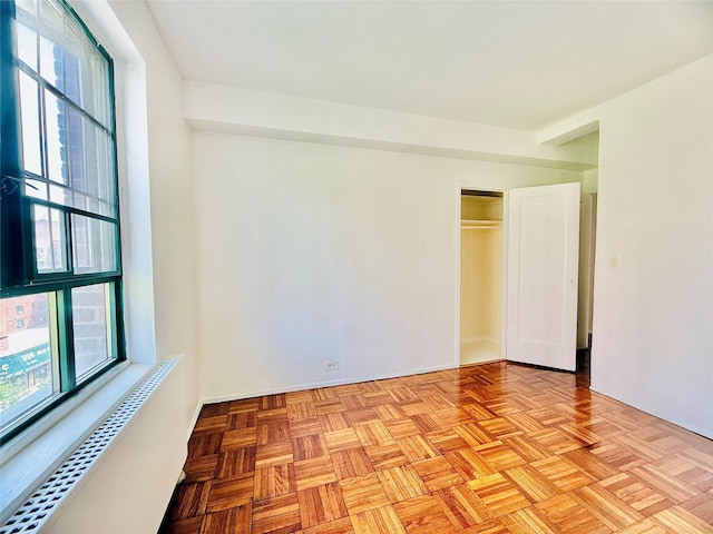 spare room featuring radiator heating unit and a baseboard heating unit