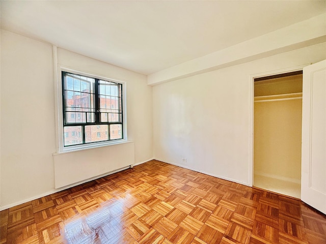 unfurnished bedroom with a closet and baseboards
