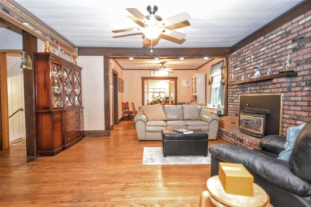 living area featuring a ceiling fan, wood finished floors, and baseboards