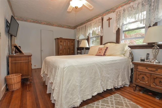 bedroom with wood-type flooring and ceiling fan