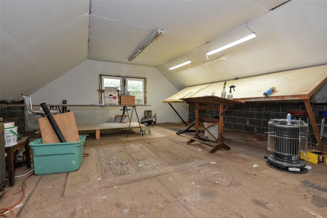 bonus room with vaulted ceiling and a workshop area