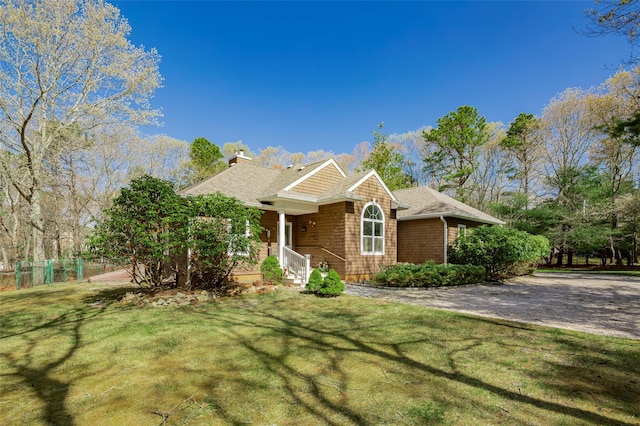 81 Lakeside Ln, Westhampton, NY 11977 - view of front of home featuring fence, a chimney, a shingled roof, and a front yard