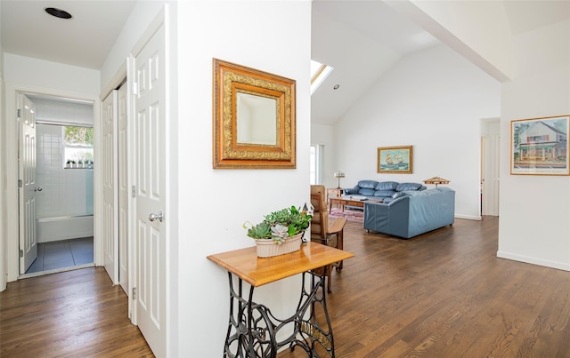 81 Lakeside Ln, Westhampton, NY 11977 - hallway with high vaulted ceiling, baseboards, and dark wood-style flooring