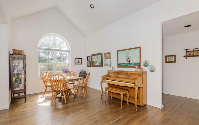 81 Lakeside Ln, Westhampton, NY 11977 - dining space featuring baseboards, high vaulted ceiling, and wood finished floors