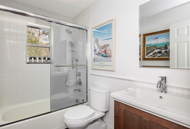 81 Lakeside Ln, Westhampton, NY 11977 - bathroom with vanity, wainscoting, combined bath / shower with glass door, and toilet