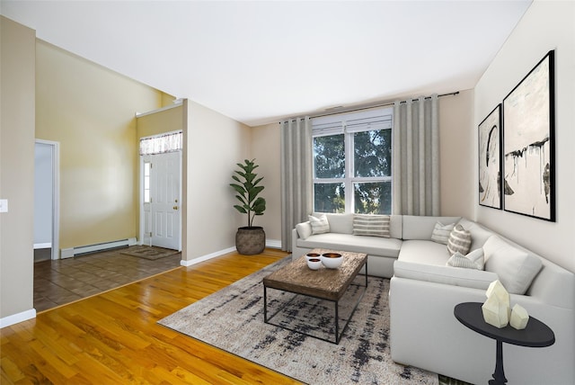 living area with a baseboard radiator, wood finished floors, and baseboards