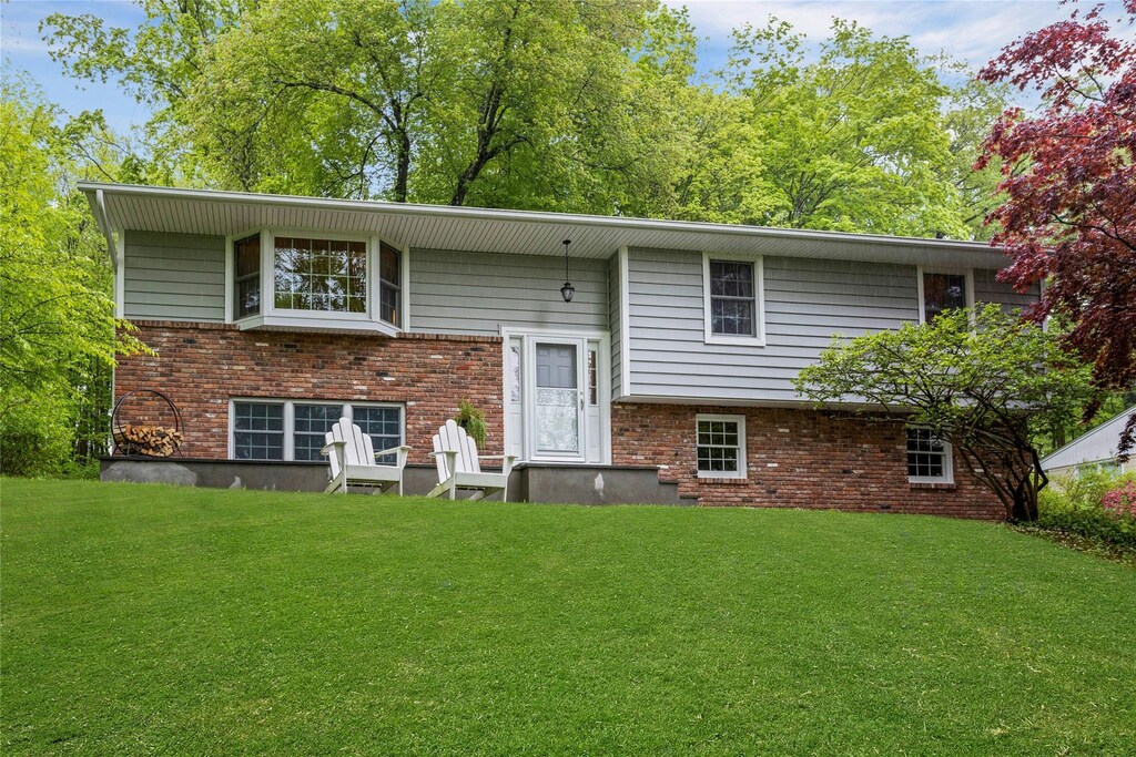 12 Truesdale Lake Dr, South Salem, NY 10590 - back of house featuring a yard and brick siding