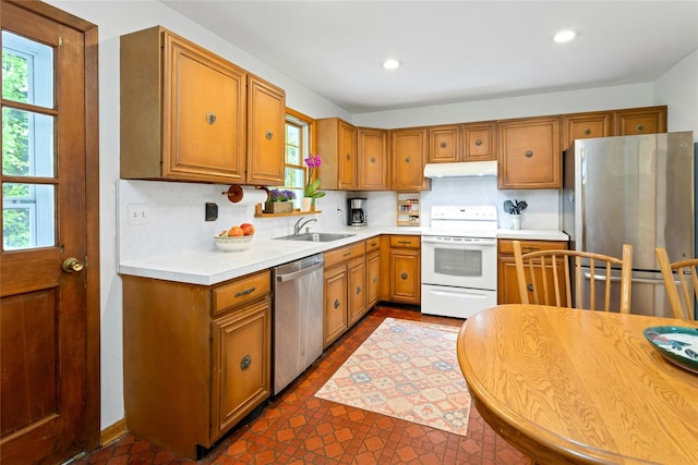 kitchen with a sink, stainless steel appliances, and a wealth of natural light