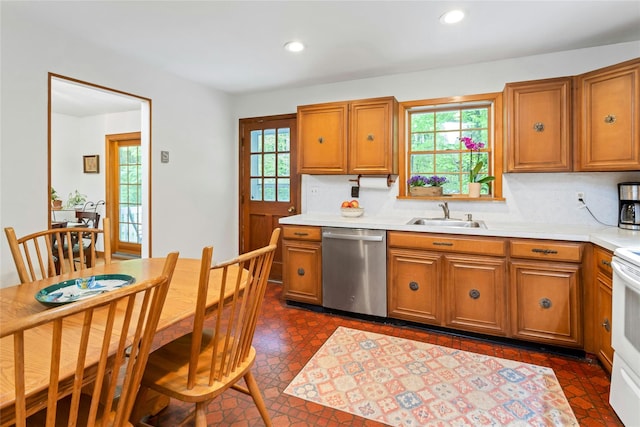 kitchen featuring brown cabinets, a sink, and stainless steel dishwasher