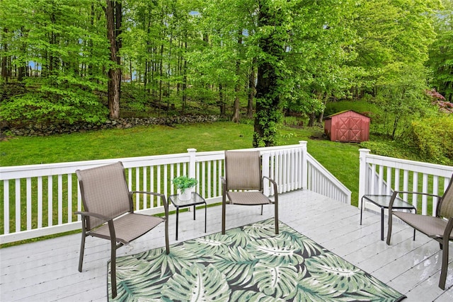 wooden deck with a yard, a storage shed, and an outbuilding