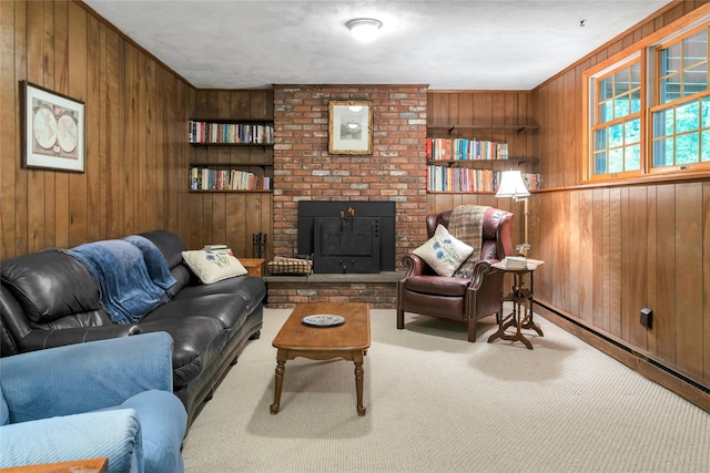 living room with wood walls, a brick fireplace, and carpet floors