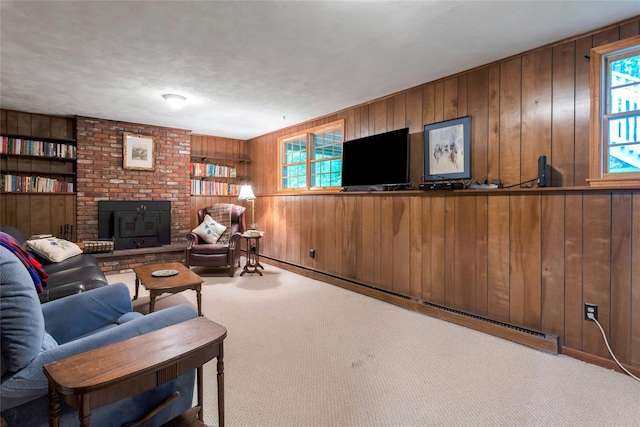 carpeted living area with a wood stove, wooden walls, and a baseboard heating unit