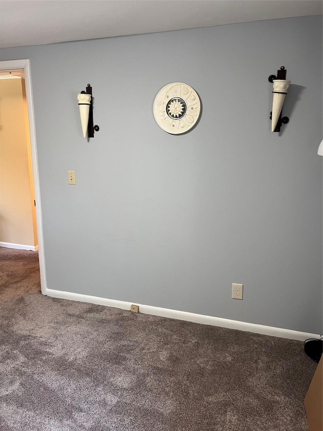 unfurnished room with baseboards and carpet flooring