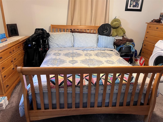 bedroom with carpet flooring and washer / dryer