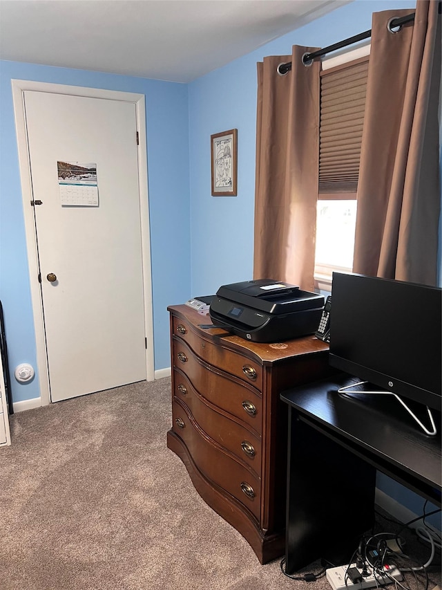 carpeted home office featuring baseboards