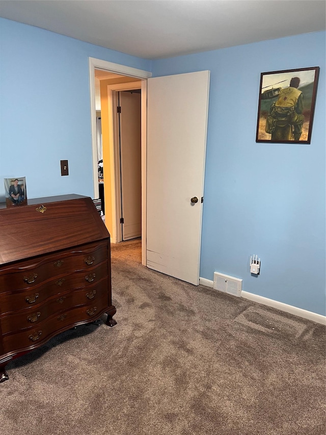 carpeted bedroom featuring visible vents and baseboards