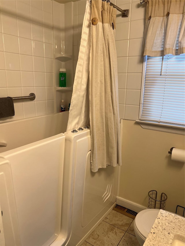 bathroom with baseboards, tile patterned floors, visible vents, and toilet