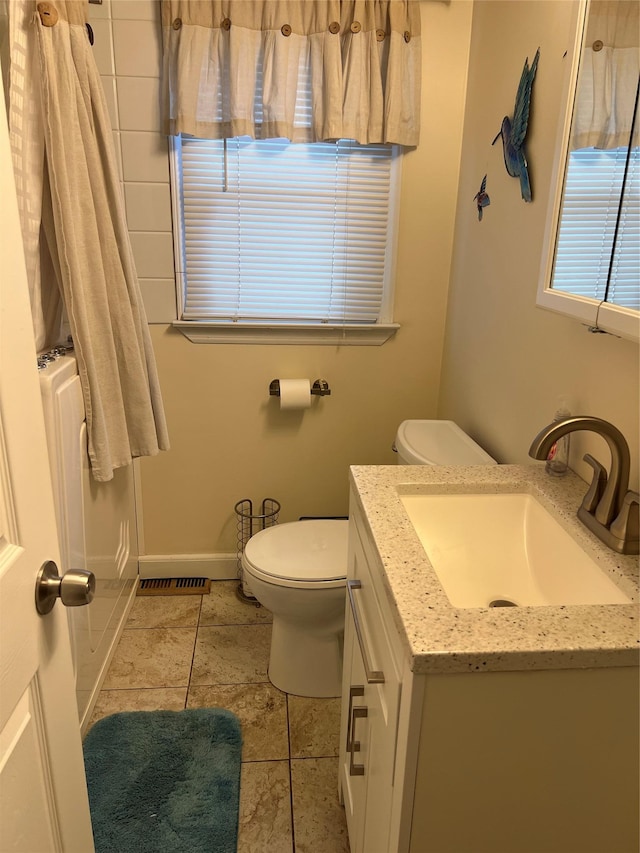 bathroom with toilet, tile patterned floors, visible vents, and vanity